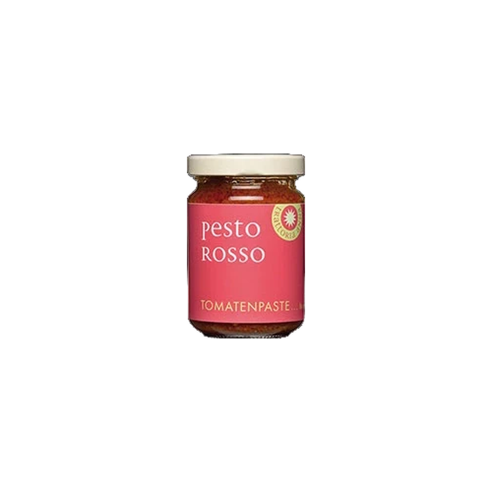 Trattoria Anna Pesto rosso im 130g-Glas mit sonnengetrockneten Tomaten, Öl und Kräutern auf hellem Untergrund.