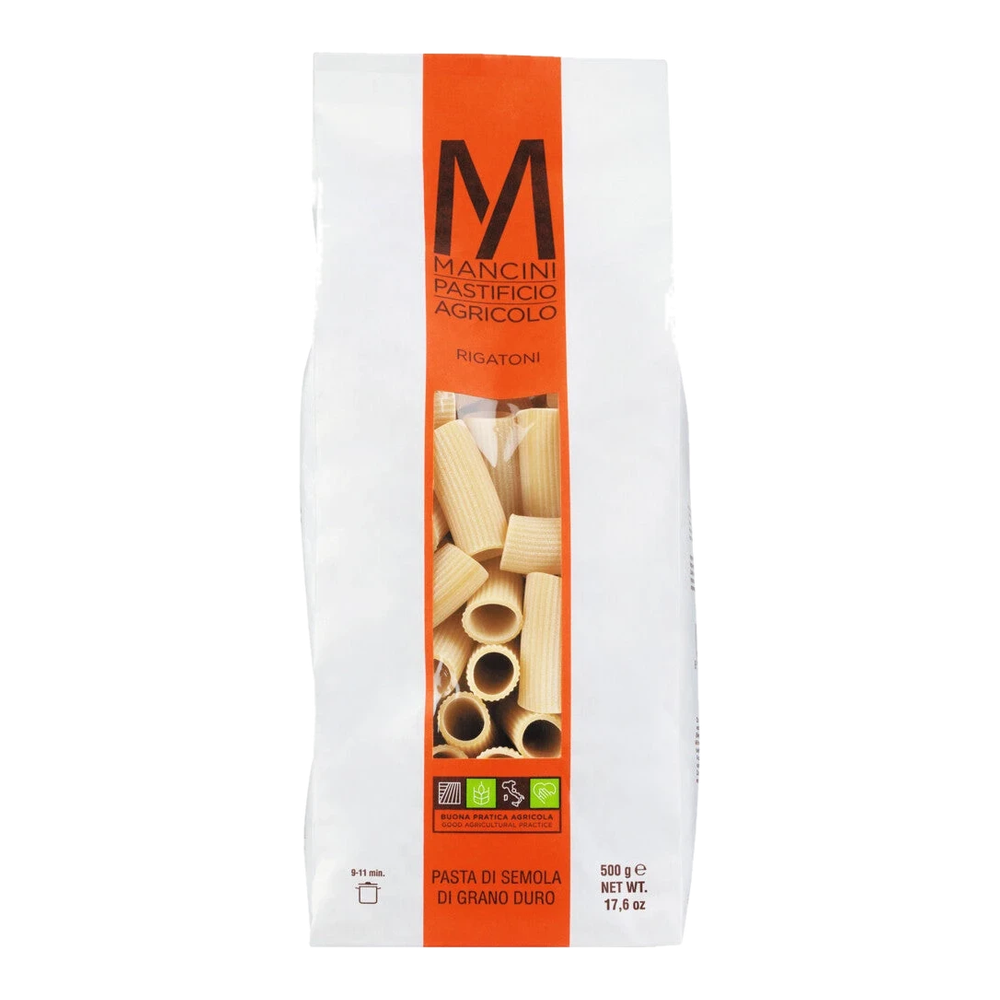 Rigatoni – ribbed, tube-shaped noodles made from durum wheat, dry and uncooked on a light background.