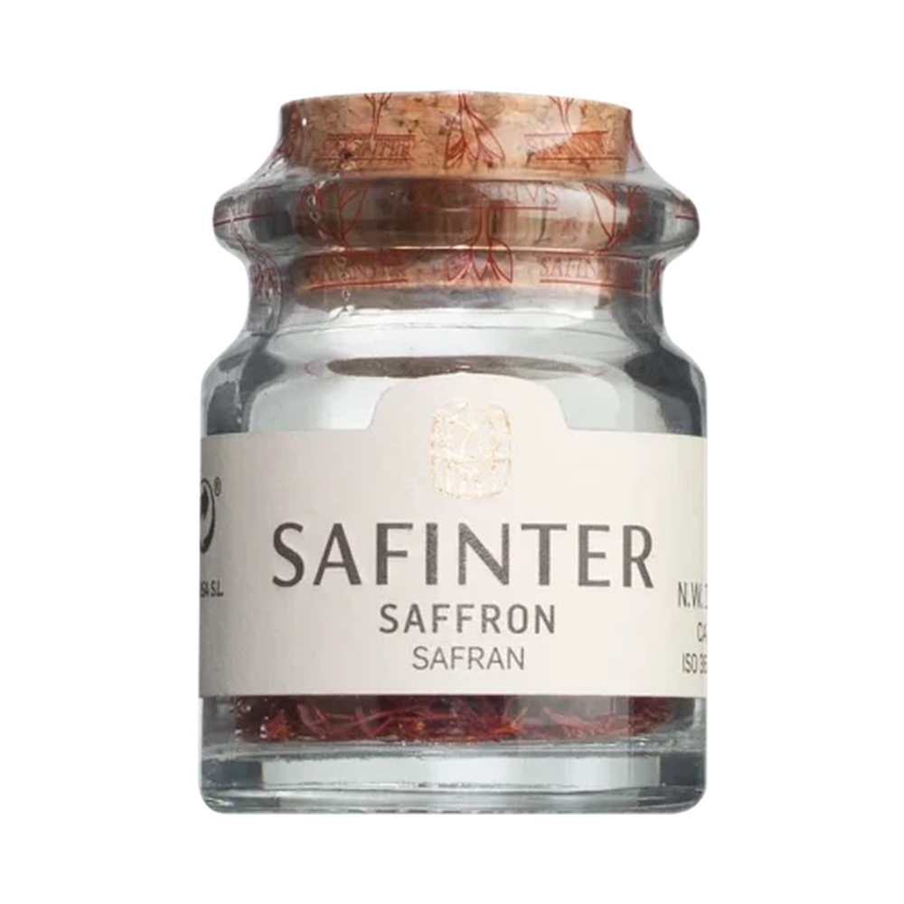 Small cork jar filled with deep orange-red, dried saffron threads — saffron in threads, Spanish