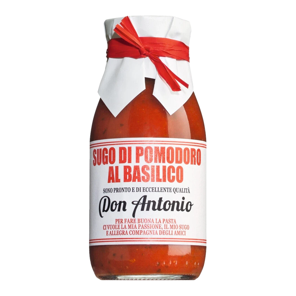 Jar of Sugo al basilico with tomatoes and basil on a light background