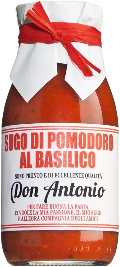 Jar of Sugo al basilico with tomatoes and basil on a light background