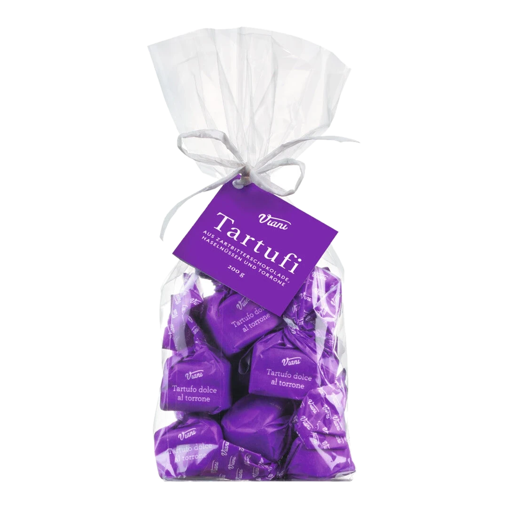 Dark chocolate balls with torrone filling made of honey, almonds and hazelnuts, approx. 14 pieces in a cellophane bag.